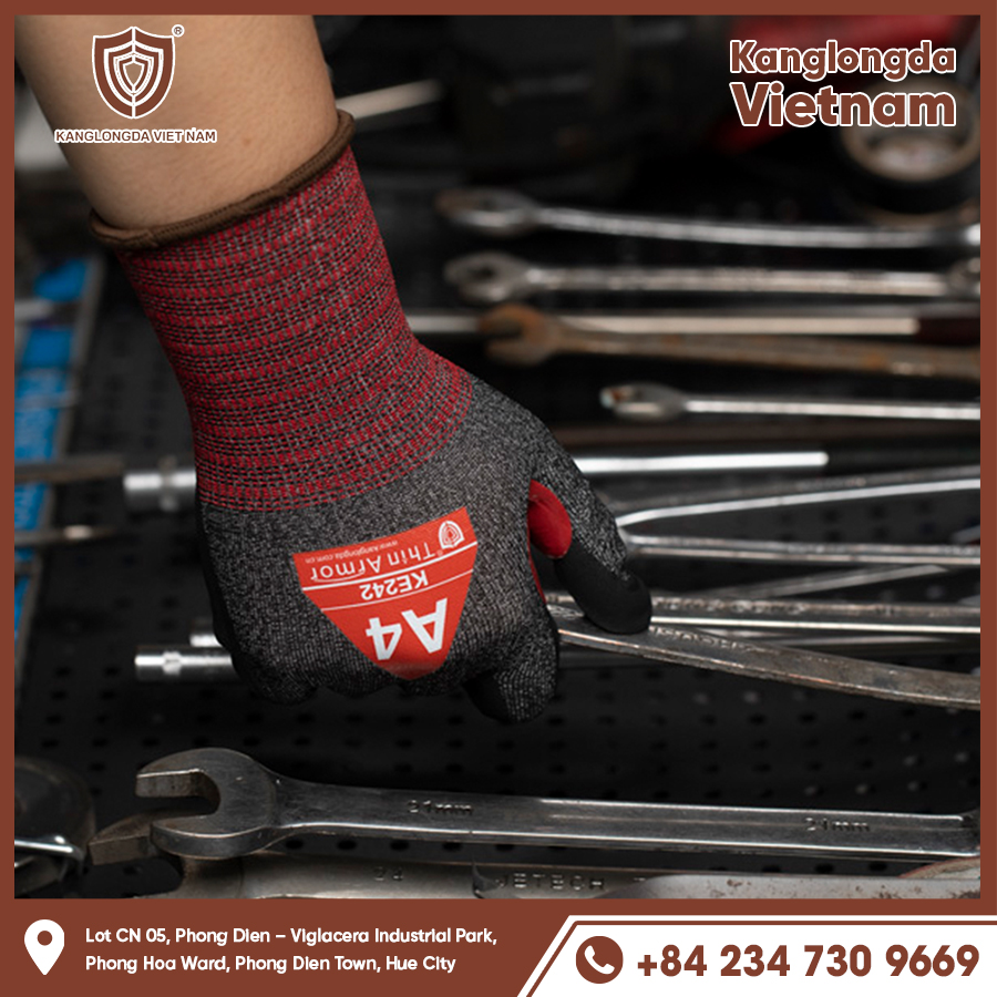 Worker wearing KE242 gloves while working with auto repair equipment Worker wearing KE242 gloves while working with auto repair equipment